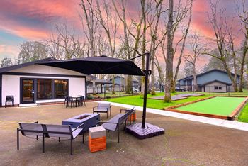 a patio with tables and chairs and umbrellas